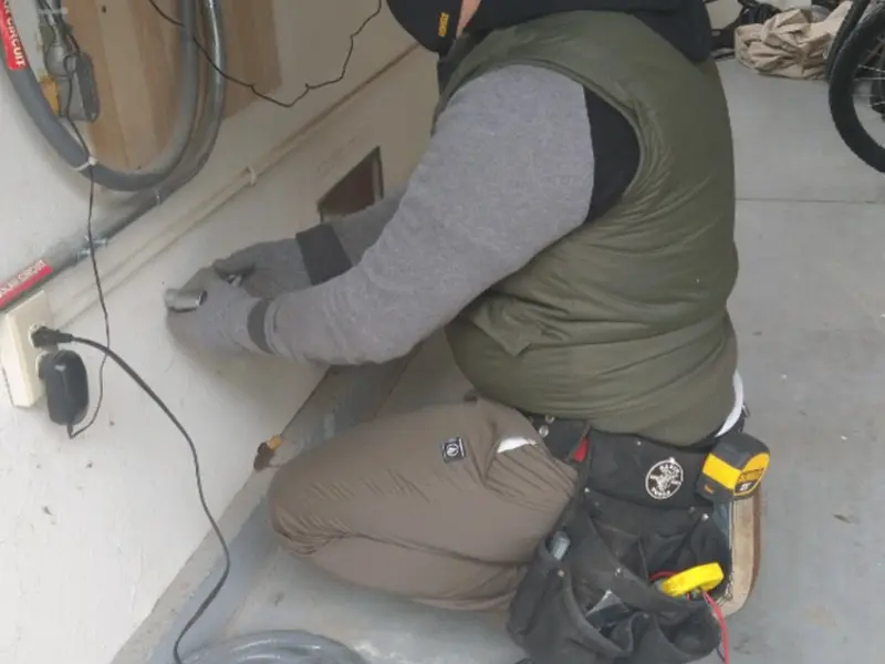 Electrician performing outlet wiring in a North El Monte garage